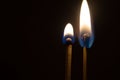 Couple of matches burning together with heat flame isolated on a black background Royalty Free Stock Photo