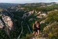 A couple meets the sunrise in the mountains, rear view. Man and woman in the mountains. Man and woman hugging. The couple travels Royalty Free Stock Photo