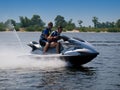 Couple men on jet ski in the river Royalty Free Stock Photo