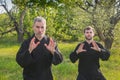 Couple men practice gymnastics in a blooming garden Royalty Free Stock Photo