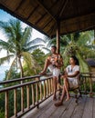 couple men and woman on balcony of beach hut with coffee in Railay beach Krabi Thailand in the morning Royalty Free Stock Photo