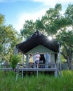 couple men and woman in front of safari tent on a luxury safary,South Africa, luxury safari lodge in the bush Royalty Free Stock Photo