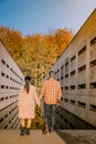 Couple men and woman hiking in the forest during autumn and small streaming water river with fall colors and orange and Royalty Free Stock Photo