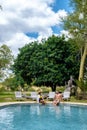 couple men and woman by the pool on a luxury safary,South Africa, luxury safari lodge in the bush Royalty Free Stock Photo