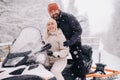 A couple, a man and a woman, on a snowmobile in a winter forest Royalty Free Stock Photo