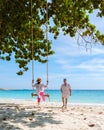 A couple of men and woman at a swing on the beach of Koh Samet Island Rayong Thailand Royalty Free Stock Photo