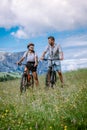 Couple men and woman on vacation in the Dolomites Italy,Alpe di Siusi - Seiser Alm with Sassolungo - Langkofel mountain Royalty Free Stock Photo