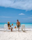 couple men and women on the beach with coconut drink, Praslin Seychelles tropical island with withe beaches and palm Royalty Free Stock Photo