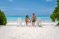 couple men and women on the beach with coconut drink, Praslin Seychelles tropical island with withe beaches and palm Royalty Free Stock Photo