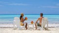 couple men and women on the beach with coconut drink, Praslin Seychelles tropical island with withe beaches and palm Royalty Free Stock Photo