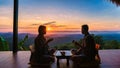 a couple of men and women on vacation in Northern Thailand staying at a homestay cabin hut