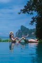 couple men and women at infinity pool looking out over the beach of Koh Phi Phi Thailand Royalty Free Stock Photo