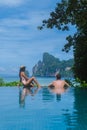 couple men and women at infinity pool looking out over the beach of Koh Phi Phi Thailand Royalty Free Stock Photo