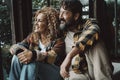 Couple man and woman mature age enjoy and relax together at home sitting on the floor and looking outside the window. Happy young Royalty Free Stock Photo