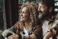 Couple man and woman mature age enjoy and relax together at home sitting on the floor and looking outside the window. Happy young Royalty Free Stock Photo