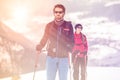 Couple man and woman skier exploring snowy land walking and skiing with alpine ski. Europe Alps. Winter sunny day, snow Royalty Free Stock Photo