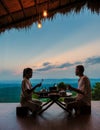 a couple of men and women on vacation in Northern Thailand staying at a homestay cabin hut