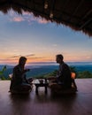 a couple of men and women on vacation in Northern Thailand staying at a homestay cabin hut