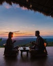 a couple of men and women on vacation in Northern Thailand staying at a homestay cabin hut