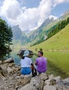 Couple of men and women visiting the Seealpsee lake in den Appenzeller mountains Ebenalp Switzerland