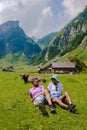 Couple of men and women visiting the Seealpsee lake in den Appenzeller mountains Ebenalp Switzerland