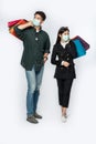 A couple of men and women wore masks and carried lots of paper bags to shop