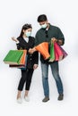 A couple of men and women wore masks and carried lots of paper bags to shop