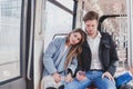 Couple in metro, young commuters sitting together