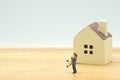 Couple Miniature 2 people standing model with house model make family Feel happy.as background real estate and family concept with Royalty Free Stock Photo