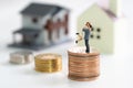 Couple Miniature 2 people standing on stack of coins to thinking