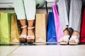 Couple of mother and daugher go shopping with a lot of bags with gifts and more - two persons sitted on the bench of the mall Royalty Free Stock Photo