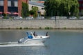 A couple in a motor boat in the river. Woman sit on rostrum of a Royalty Free Stock Photo