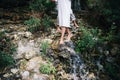 Couple on the mountain stream background. foot walking across the waterfall, springwater