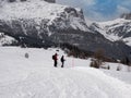 Couple of Mountaineers Admiring and Pointing out the Surrounding Snowy Panorama of the Beautiful Italian Alps Mountains