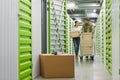 Couple Moving Boxes in Storage Unit Royalty Free Stock Photo