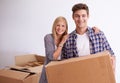 Couple, moving and new home with box for packing, happy with real estate and support with smile in portrait. Property Royalty Free Stock Photo