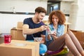 Couple Moving Into New Home Enjoying Takeaway Meal Royalty Free Stock Photo