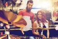 Couple of musicians with drum kit at music store