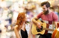 Couple of musicians playing guitar over lights