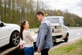 Couple near broken car on a roadside Royalty Free Stock Photo