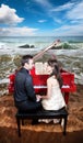Couple near the piano on the beach Royalty Free Stock Photo