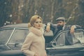 Couple near a retro car outdoors traveling. Royalty Free Stock Photo