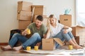 Couple in new apartment unpacking cardboard boxes Royalty Free Stock Photo