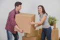 Couple in a new flat. Young man is totaly exhausted. He can not hold heavy box anymore, he almost dropped it, but woman