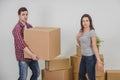 Couple in a new flat. Young man is totaly exhausted. He can not hold heavy box anymore, but woman doesn`t know where to