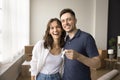 Couple of new home owners holding keys from new flat Royalty Free Stock Photo