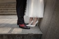 A couple of newlyweds are standing, legs in shoes close-up. Newlyweds without faces. Royalty Free Stock Photo