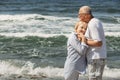 A couple of nice old people. The man holds the woman's hands. she puts her head on his chest