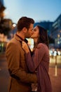 Couple, night and city with kiss on date, romance and bonding with love in relationship. Happiness, affection and people Royalty Free Stock Photo