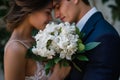 couple nosetonose, a lush bouquet of gardenias held between them Royalty Free Stock Photo